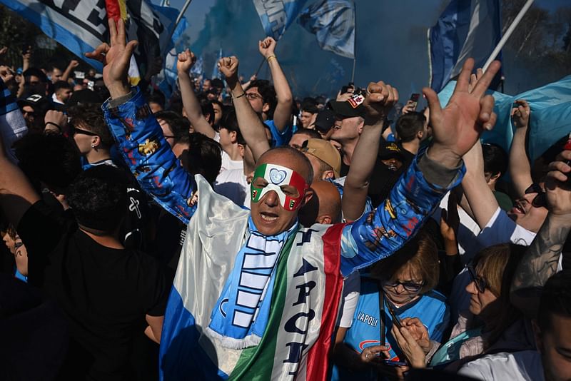 Fans of SSC Napoli gather on 5 May 2023 outside the club's training centre in Castel Volturno, north of Naples, to welcome Napoli's players whose plane is expected to land at the nearby military airport of Caserta - Grazzanise, a day after Napoli won the Italian champions "Scudetto" title following a decisive match in Udine