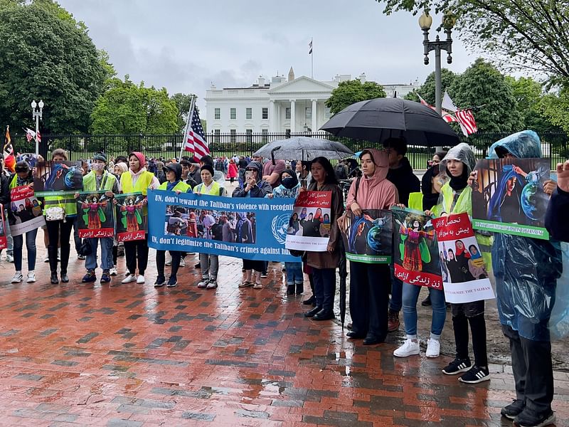 Activists hold banners during a demonstration in front of the White House in Washington, DC, on 30 April, 2023