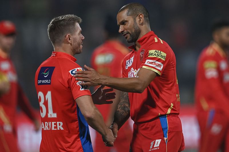 Punjab Kings' Shikhar Dhawan shakes hands with Delhi Capitals' David Warner at the end of the IPL match between Delhi Capitals and Punjab Kings at the Arun Jaitley Stadium in New Delhi on 13 May 2023