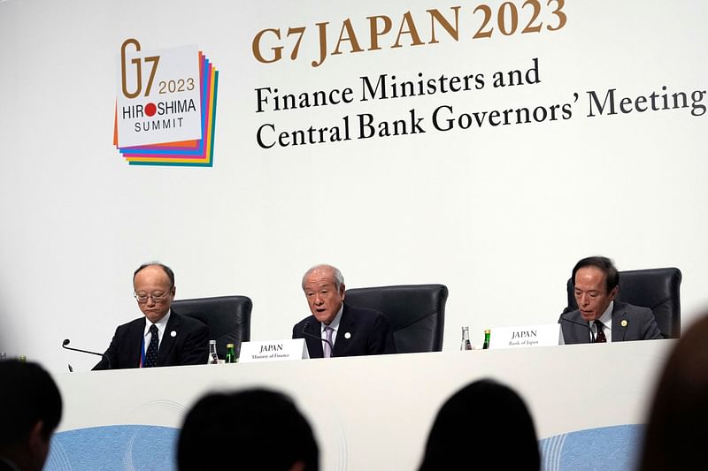 Japanese Finance Minister Shunichi Suzuki (C) speaks next to Governor of the Bank of Japan Kazuo Ueda (R) during the presidency press conference at the G7 Finance Ministers and Central Bank Governors' Meeting at Toki Messe in Niigata on 13 May, 2023