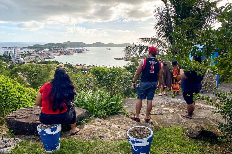 People look out toward the seafront from the Vierge du Pacifique in Noumea on 19 May 2023, after an earthquake hit the island. A tsunami warning in the Pacific has been lifted after a 7.7-magnitude earthquake struck on 19 May sent many islanders in the region fleeing the coast