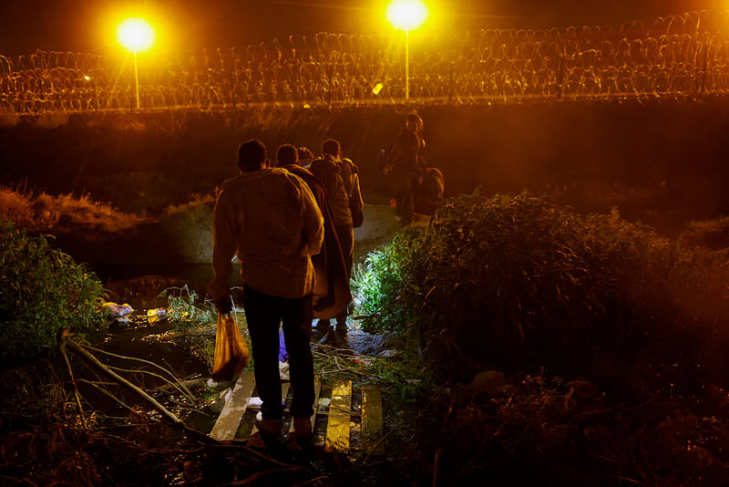 Migrants cross the Rio Bravo river with the intention of turning themselves in to the US Border Patrol agents, as seen from Ciudad Juarez, Mexico on 5 May, 2023