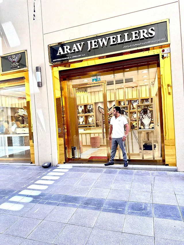 Rabiul Islam alias Arav standing in front of 'Arav Jewellers' in Dubai.