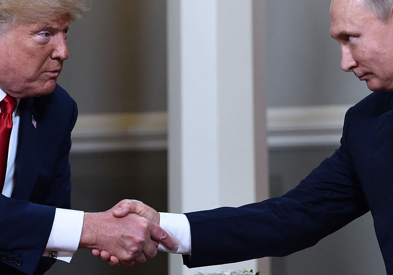 US President Donald Trump (L) and Russian President Vladimir Putin shake hands ahead of a meeting in Helsinki on July 16, 2018