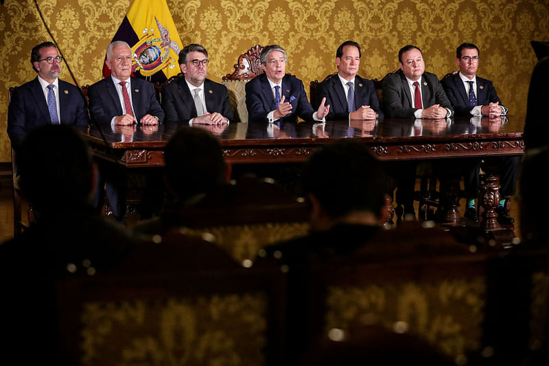 Ecuador's President Guillermo Lasso addresses the nation next to members of government, after he dissolved the National Assembly by decree, bringing forward legislative and presidential elections, a day after he defended himself in an impeachment hearing, in Quito, Ecuador May 17, 2023