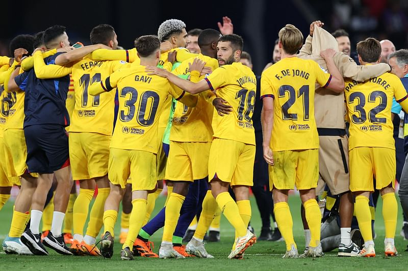 Barcelona’s players celebrate winning their 27th Spanish league championship after the Spanish league football match between RCD Espanyol and FC Barcelona at the RCDE Stadium in Cornella de Llobregat on 14 May, 2023