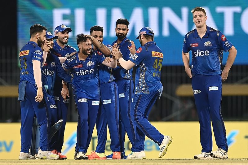 Mumbai Indians' Akash Madhwal (4L) celebrates with teammates after the dismissal of Lucknow Super Giants' Mohsin Khan (not pictured) during the Indian Premier League (IPL) Twenty20 eliminator cricket match between Lucknow Super Giants and Mumbai Indians at the MA Chidambaram Stadium in Chennai on 24 May, 2023