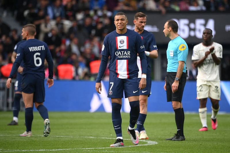 Paris Saint-Germain's French forward Kylian Mbappe (C) reacts during the French L1 football match between Paris Saint-Germain (PSG) and FC Lorient at The Parc des Princes Stadium in Paris on 30 April, 2023