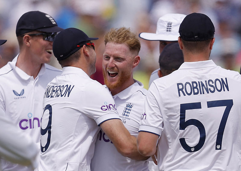 England's Ben Stokes celebrates with James Anderson after taking the wicket of Australia's Steven Smith in the first Ashes Test at the Edgbaston Cricket Ground in Birmingham, Britain on 17 June 2023