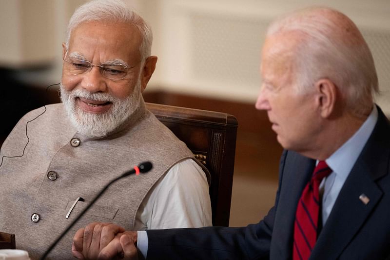 India's Prime Minister Narendra Modi and US President Joe Biden embrace hands during a meeting with senior officials and CEOs of American and Indian companies, in the East Room the White House in Washington, DC, on 23 June, 2023