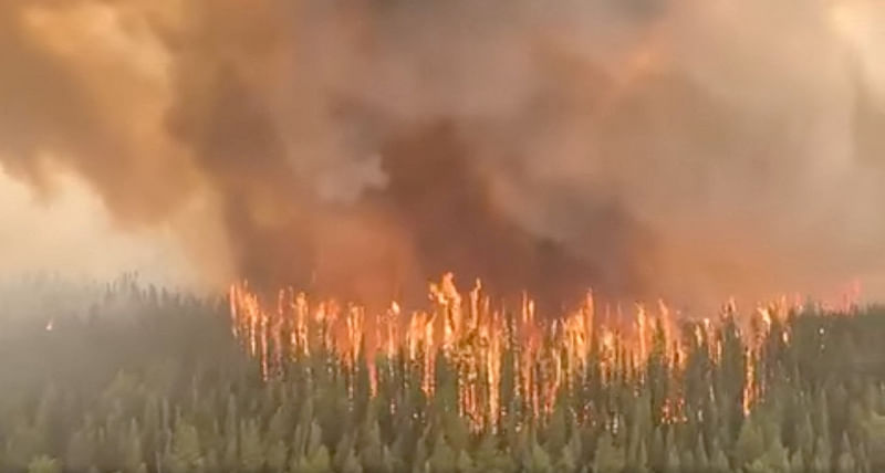 An aerial view shows West Kiskatinaw River wildfire in British Columbia, Canada, on 9 June, 2023 in this screen grab obtained from a social media video