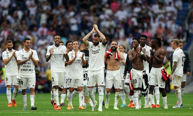 Real Madrid's French forward Karim Benzema (C) applauds surrounded by teammates at the end of the Spanish league football match between Real Madrid CF and Athletic Club Bilbao at the Santiago Bernabeu stadium in Madrid on 
4 June, 2023