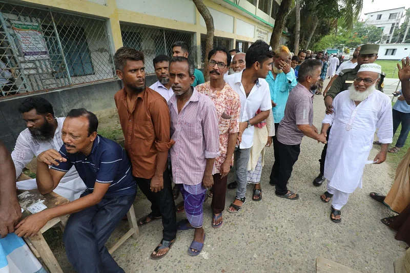 Voters wait in line to cast their votes in Barishal city corporation elections