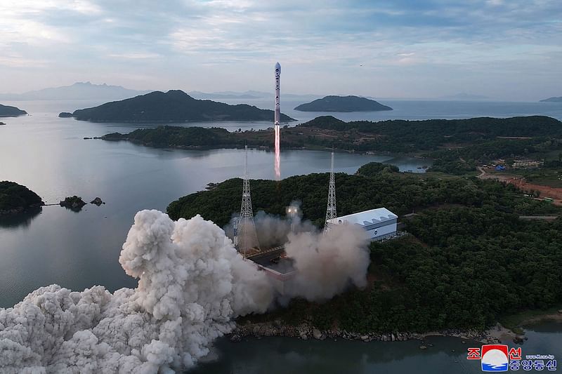 This picture taken on May 31, 2023 and released from North Korea's official Korean Central News Agency (KCNA) on 1 June, 2023 shows a new satellite-carrying rocket as it leaves the launch pad, at an undisclosed location in North Korea