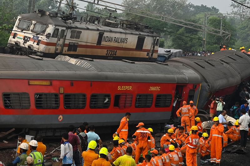 Rescue workers gather near damaged carriages at the accident site of a three-train collision near Balasore, about 200 km (125 miles) from the state capital Bhubaneswar in the eastern state of Odisha, on June 2023. At least 288 people were killed and more than 850 injured in a horrific three-train collision in India, officials said on June 3, the country's deadliest rail accident in more than 20 years.