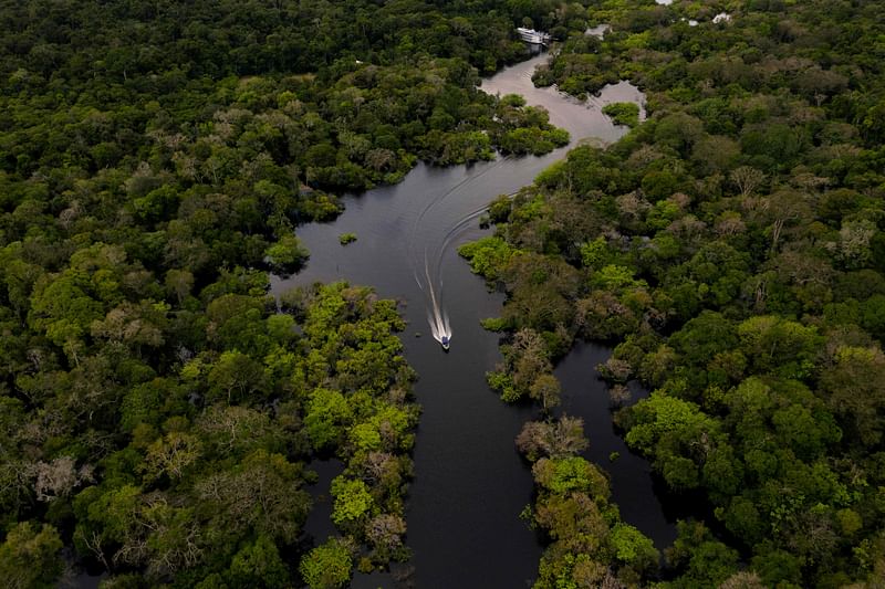 Aerial view showing a boat speeding on the Jurura river in the municipality of Carauari, in the heart of the Brazilian Amazon Forest, on 15 March, 2020.