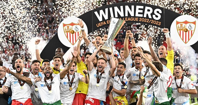 Sevilla's players celebrate with the trophy after winning the UEFA Europa League final football match between Sevilla FC and AS Roma at the Puskas Arena in Budapest, Hungary on 31 May, 2023