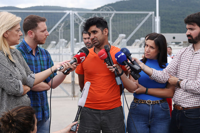 Pakistani Adil Hussain, who says his brother Matloob, 43, was onboard a boat with migrants that capsized at open sea off Greece, speaks with journalists in front of a migrant camp in Malakasa, near Athens, Greece, June 16, 2023