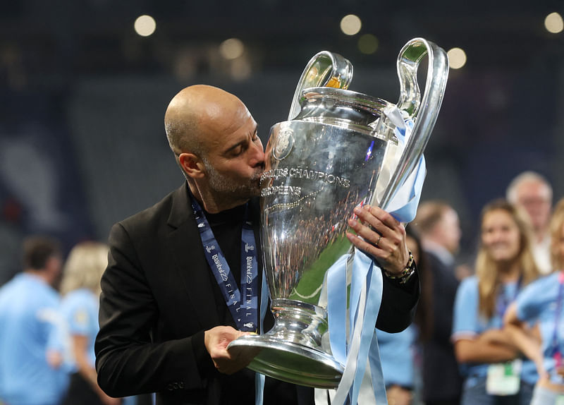 Manchester City manager Pep Guardiola kisses the trophy as he celebrates winning the Champions League