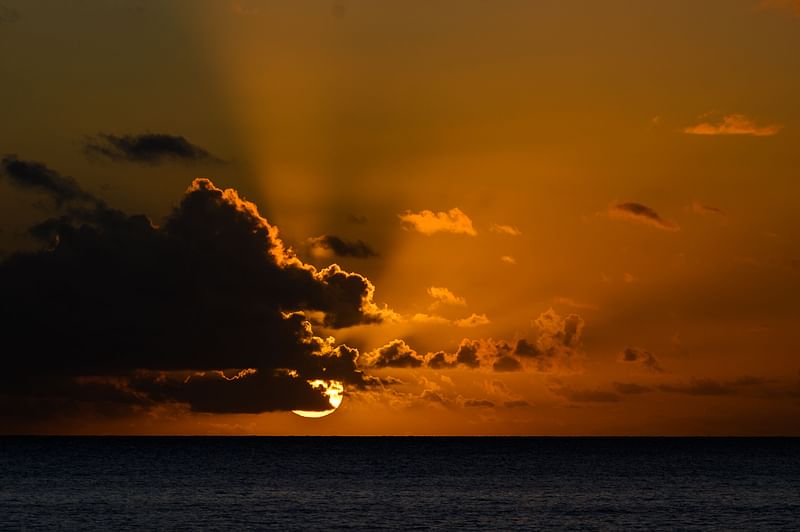 A photograph shows the sunset in Mtsangadoua on the French Indian Ocean island of Mayotte on 28 May, 2023. The first international treaty to protect the high seas is due to be adopted on 19 June, 2023 at the United Nations; an official baptism for a "historic" agreement aimed at limiting threats to the ocean and its vital ecosystems for humanity