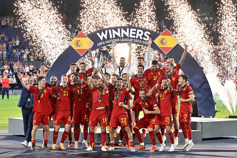 Spain's players celebrate on the podium with the UEFA Nations League after winning the UEFA Nations League final between Croatia and Spain at the De Kuip Stadium in Rotterdam on 18 June 2023