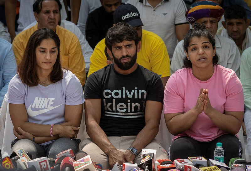 Indian wrestlers Vinesh Phogat, Bajrang Punia, and Sakshi Malik address a news conference as they take part in a sit-in protest demanding the arrest of the Wrestling Federation of India (WFI) chief, who they accuse of sexually harassing female players, in New Delhi, India, 24 April 2023.