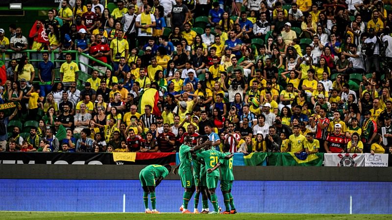 Senegal’s players celebrate after Brazil's defender Marquinhos scored an own goal during the international friendly football match between Brazil and Senegal at the Jose Alvalade stadium in Lisbon on 20 June, 2023