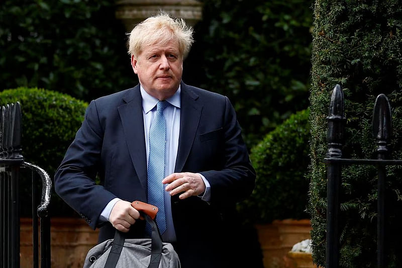 Former British Prime Minister Boris Johnson walks outside his home, in London, Britain, on 22 March, 2023.