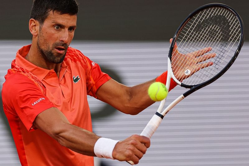 Serbia's Novak Djokovic plays a backhand return to Hungary's Marton Fucsovics during their men's singles match on day four of the Roland-Garros Open tennis tournament at the Court Philippe-Chatrier in Paris on 31 May, 2023