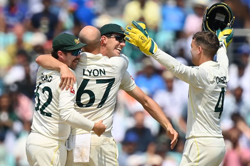 Australia's Nathan Lyon celebrates with teammates Travis Head, Pat Cummins and wicketkeeper Alex Carey after the dismissal of India's Mohammed Shami for victory during play on day 5 of the ICC World Test Championship final between Australia and India at The Oval in London on 11 June 2023