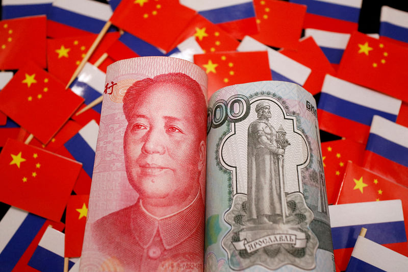 Banknotes of Chinese yuan and Russian rouble are seen amid flags of China and Russia in this illustration picture taken 15 September 2022.