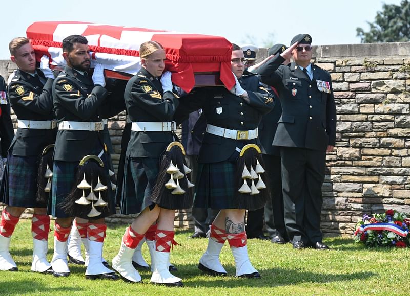 Soldiers from the Canadian Army's Calgary Highlanders carry the coffin of one of the three Canadian soldiers who died during the First World War as they are buried during a funeral service at the English military cemetery of the Commonwealth War Graves Commission (CWGC) in Loos-en-Gohelle, near Lens, northern France, on June 8, 2023