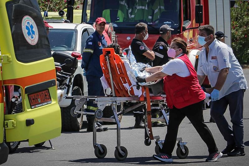 Medics transfer a survivor to an ambulance in the port of Kalamata, after a boat carrying dozens of migrants sank in international waters in the Ionian Sea on 14 June 2023. At least 59 people died while some 100 people were rescued after the boat capsized.