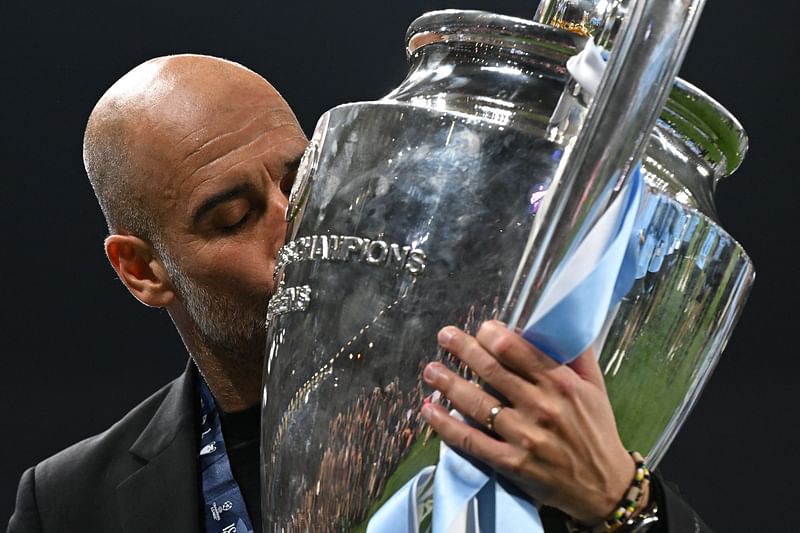 Manchester City's Spanish manager Pep Guardiola kisses the European Cup trophy as they celebrate winning the UEFA Champions League final between Inter Milan and Manchester City at the Ataturk Olympic Stadium in Istanbul, on 10 June 2023