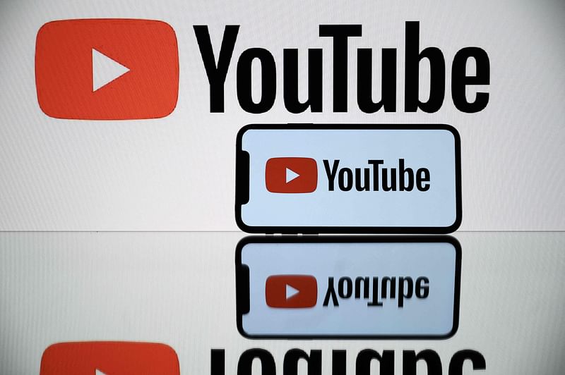 A picture taken on 5 October, 2021 in Toulouse shows the logo of Youtube social media displayed by a by a tablet and a smartphone. YouTube will stop removing content that falsely claims the 2020 US elections were plagued by "fraud, errors or glitches," the platform said in a policy reversal that drew a rebuke from campaigners.