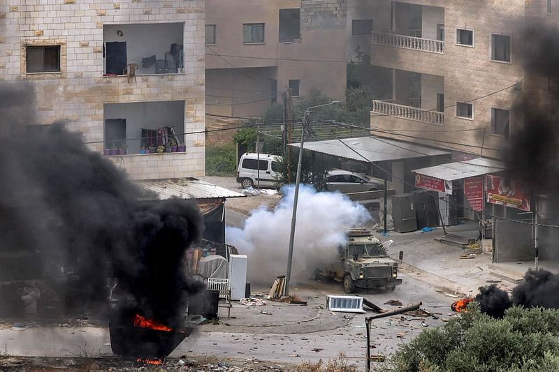 An explosive charge left by Palestinians detonates by an Israeli armoured vehicle during an Israeli army raid in Jenin in the occupied West Bank on 19 June, 2023