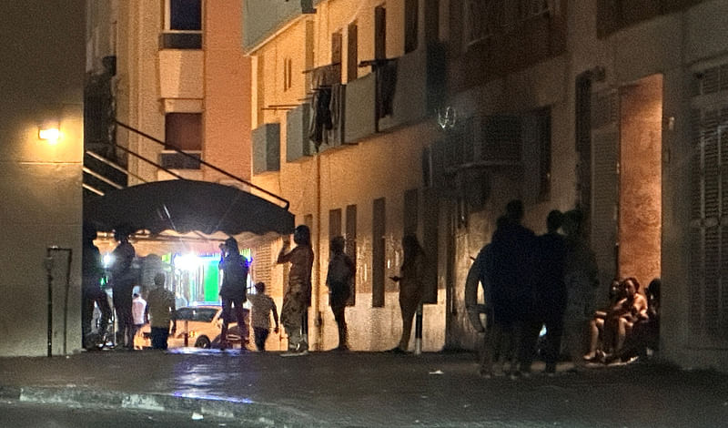 A night time view of Al Baraha neighborhood in the Deira district, Dubai, United Arab Emirates, May 26, 2023. Women in colorful wigs and low-cut dresses can be seen in front of buildings on the streets of Deira where men sit in stairways waiting their turn with the women