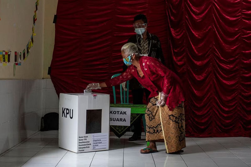 A woman casts her ballot during regional elections amid the COVID-19 pandemic in Sleman, Yogyakarta province, Indonesia on 9 December, 2020.