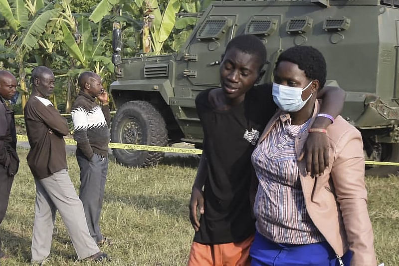 A boy is comforted at the scene of an attack in Mpondwe, Uganda, on 17 June, 2023 at the Mpondwe Lhubiriha Secondary School. The death toll from an attack on a school in western Uganda by militants linked to the Islamic State group has risen to 37, the country's army spokesman said Saturday.