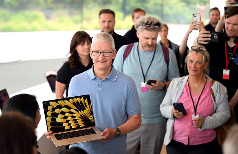 Apple CEO Tim Cook speaks with media members at a viewing area for new products during Apple’s Worldwide Developers Conference (WWDC) at the Apple Park campus in Cupertino, California, on June 5, 2023