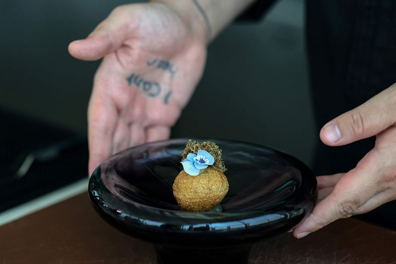 A chef prepares a dish at Moonrise Middle Eastern-Japanese fusion restaurant in Dubai on 3 July, 2023.