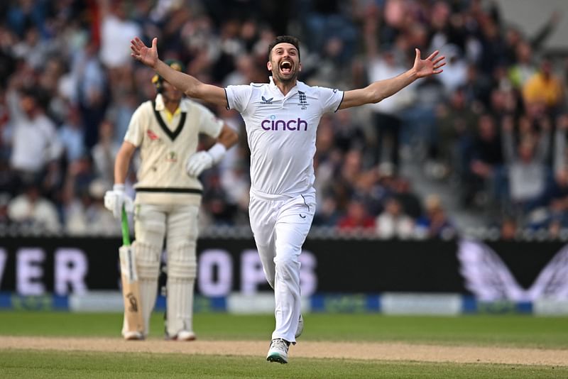 England's Mark Wood celebrates after taking the wicket of Australia's Travis Head on day three of the fourth Ashes cricket Test match between England and Australia at Old Trafford cricket ground in Manchester, north-west England on 21 July, 2023