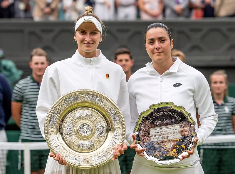 Czech Republic's Marketa Vondrousova (L) holding the Venus Rosewater Dish next to Tunisia's Ons Jabeur holding her prize, pose for pictures during the ceremony at the end of the women's singles final tennis match against on the thirteenth day of the 2023 Wimbledon Championships at The All England Lawn Tennis Club in Wimbledon, southwest London, on July 15, 2023