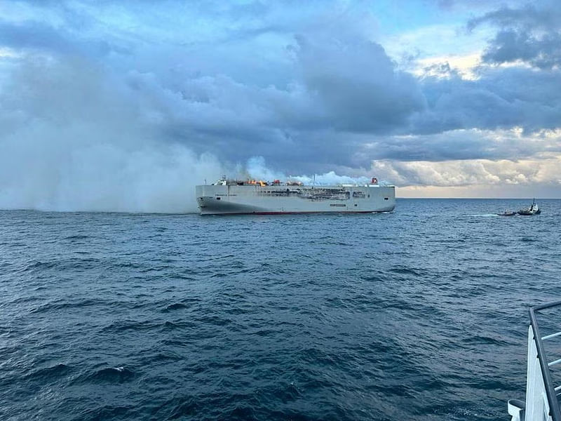 A fire blazed on a ship off the Dutch coast with nearly 3,000 vehicles on board on Wednesday, killing one member of the crew and injuring several others, the coastguard said.