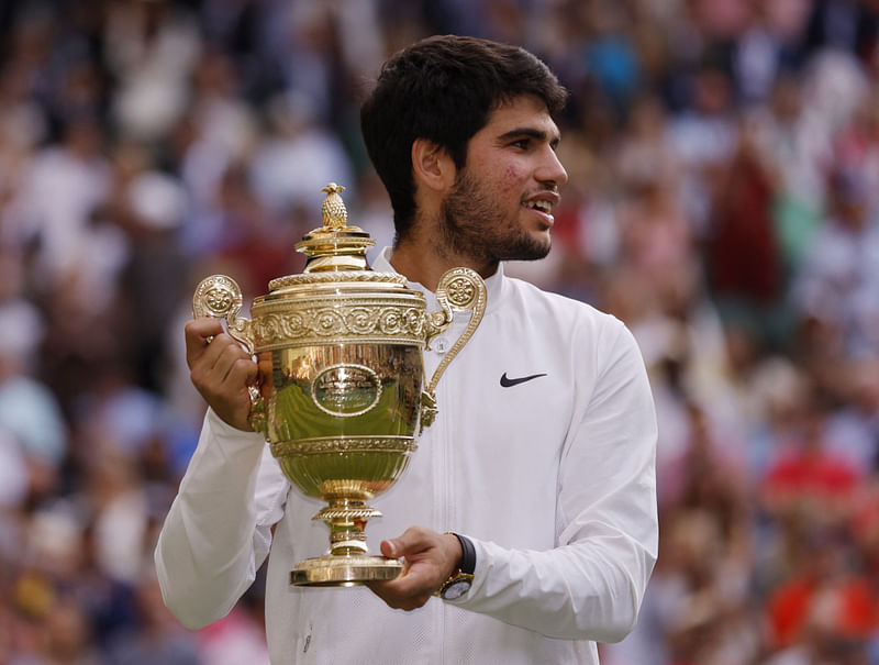 Spain's Carlos Alcaraz celebrates with the trophy after winning his final match against Serbia's Novak Djokovic