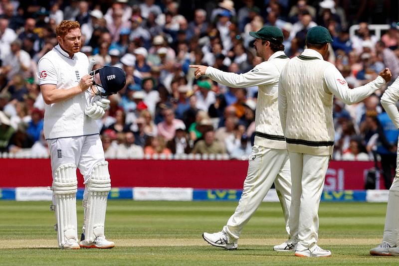 Australia's Travis Head (C) points as he talks with England's Jonny Bairstow whilst the await the successfully appeal for Bairstow's wicket for 10 runs on day five of the second Ashes cricket Test match between England and Australia at Lord's cricket ground in London on 2 July, 2023