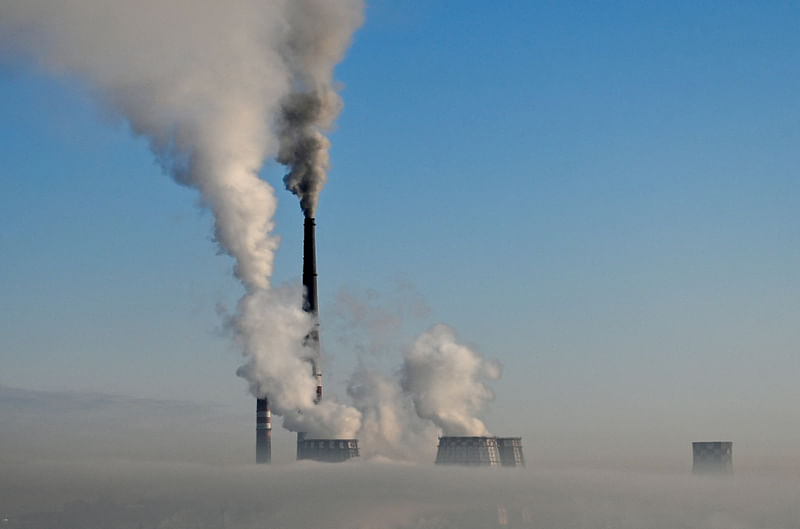 Flue gas and steam rise out of chimneys of a thermal power plant amidst heavy smog on a frosty day in the Siberian city of Omsk, Russia, 3 February, 2023.