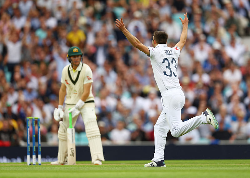 England's Mark Wood celebrates after taking the wicket of Australia's Marnus Labuschagne