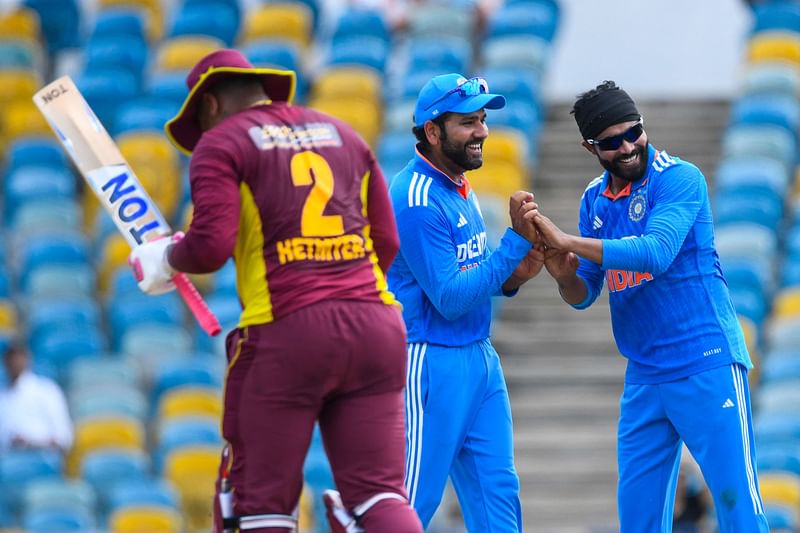 Ravindra Jadeja and Rohit Sharma of India celebrate the dismissal of Shimron Hetmyer of West Indies during during the first One-Day International between West Indies and India, at Kensington Oval in Bridgetown, Barbados, on 27 July 2023