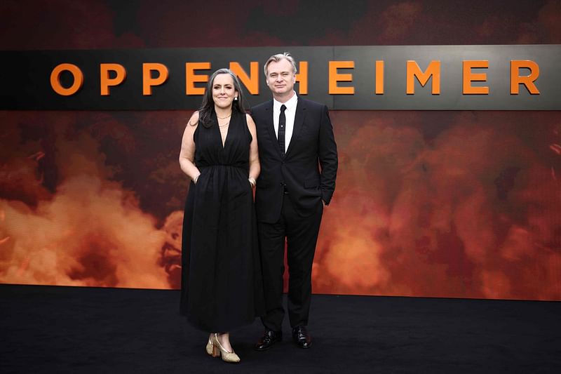 British film producer Emma Thomas (L) and her husband British-US film director Christopher Nolan (R) pose on the red carpet upon arrival for the UK premiere of "Oppenheimer" in central London on July 13, 2023